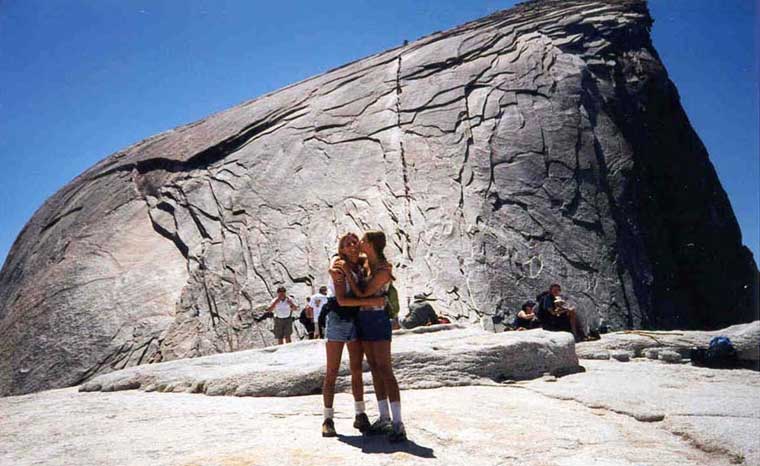 Lani kissing Wendy in front of Half Dome, Yosemite National Park