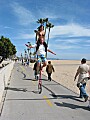 Julie sitting on Eric's shoulders, while he rides his unicycle down the strand: Balboa Peninsula, Newport Beach, California