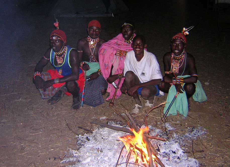 Locals gather 'round a campfire in northern Kenya