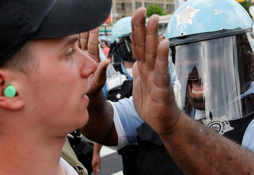At NATO Protest, Chicago Police Officer Confronts Protester Wearing Green Ear Plugs on May 20, 2012