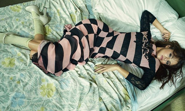 Selena lying fully reclined on the bed in pink-n-black Vogue Australia September 2016